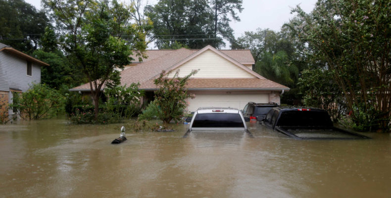 Houses and cars are seen partially submerged by flood waters from tropical storm Harvey in east Houston, Texas, U.S., August 28, 2017. REUTERS/Jonathan Bachman