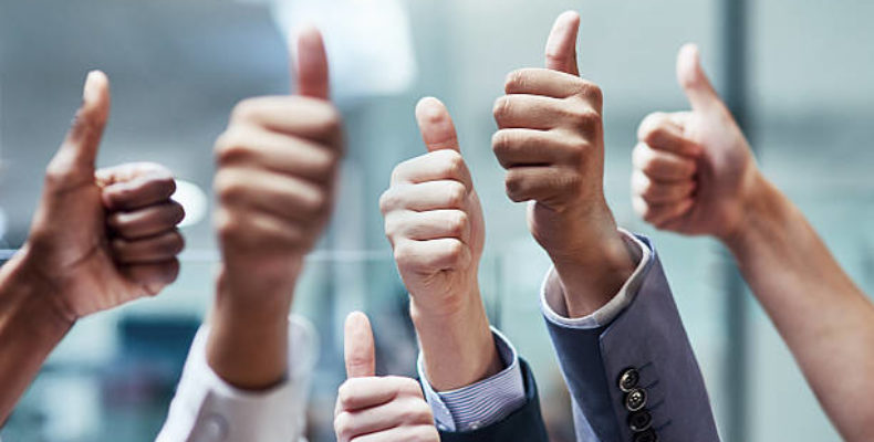 Shot of a group of hands showing thumbs up